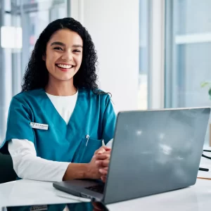 Happy Nurse working on Laptop
