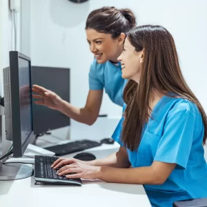 Team of Nurses Collaborating at Computer in Modern Medical Work Environment