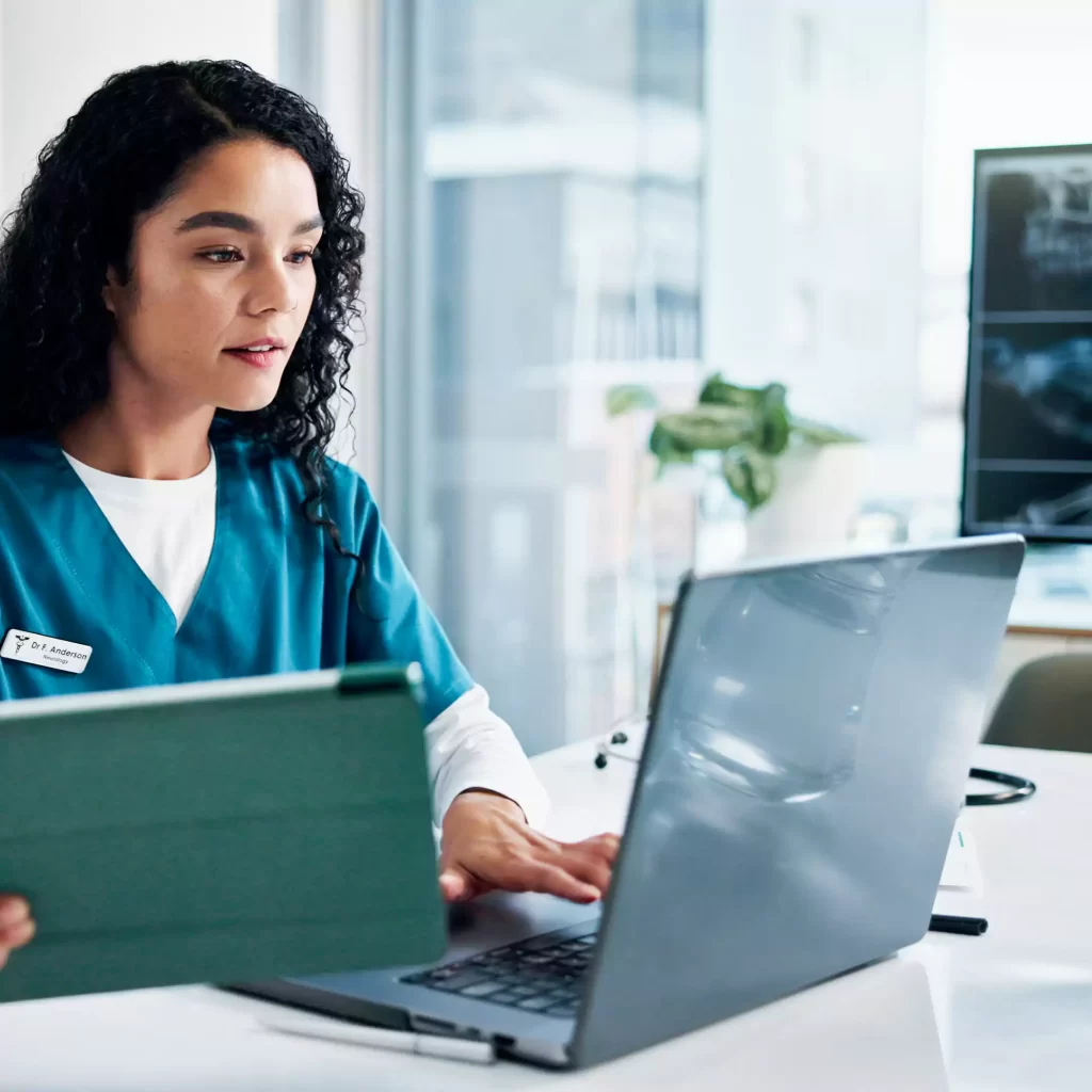 Woman, nurse or reading with laptop or tablet for medical research, discovery or study at hospital.