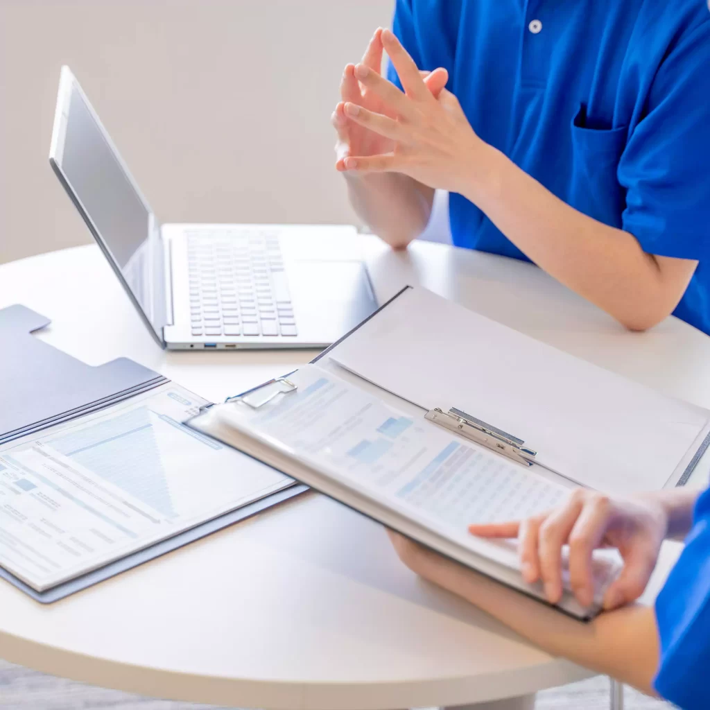 The hands of male and female caregivers having a meeting