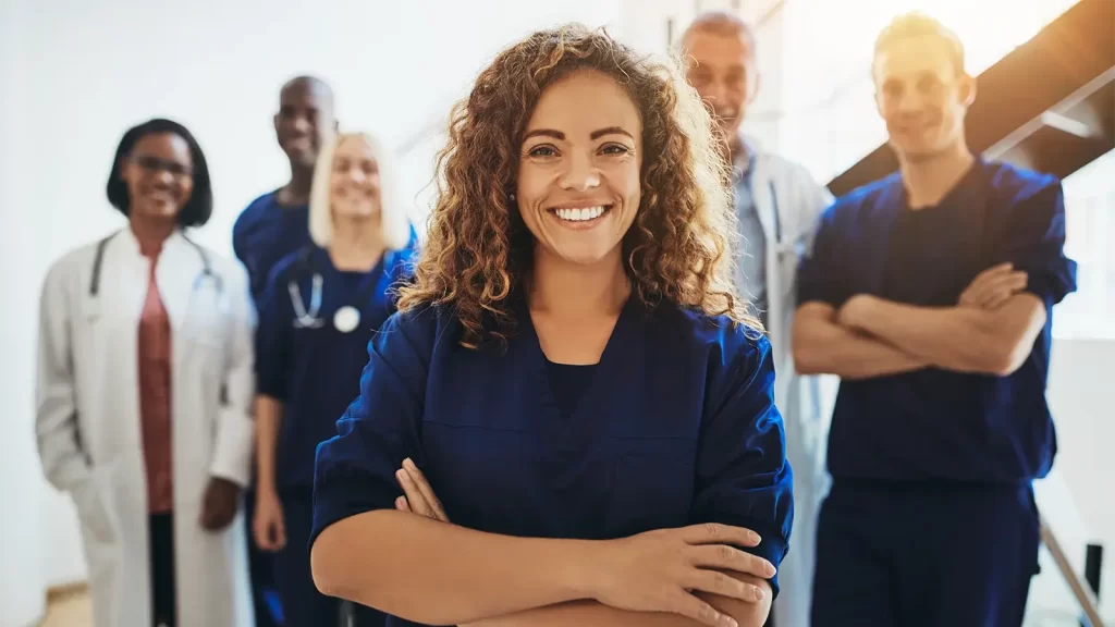 Smiling female doctor standing with medical staff in a hospital
