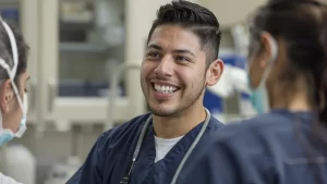 Male Certified Nursing Aide working with staff in a doctor office