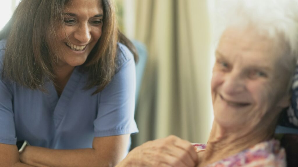 Nurse smiling with an elderly patient