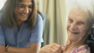 Nurse smiling with an elderly patient