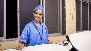 Smiling clinician in surgical attire