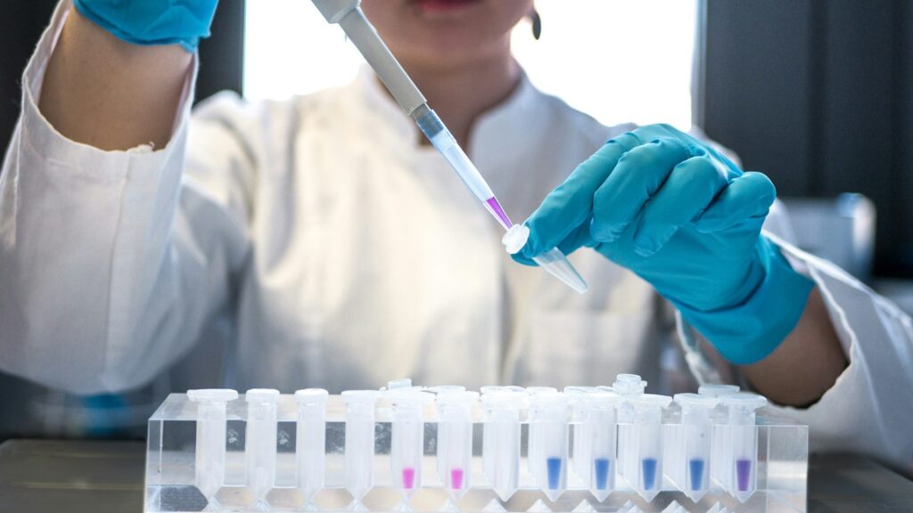 Lab technician using a pipette
