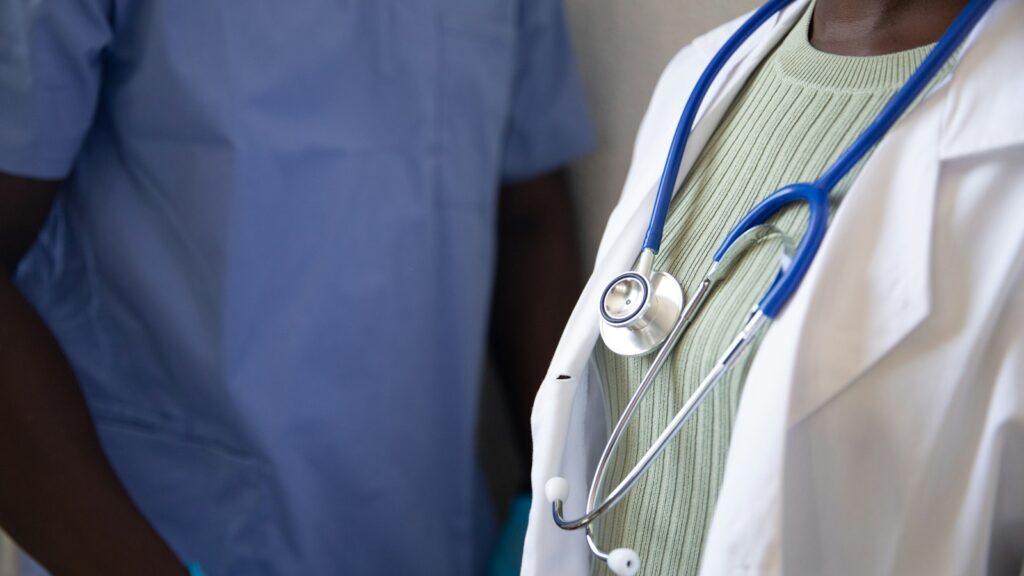 Clinician holding a stethoscope