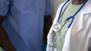 Clinician holding a stethoscope
